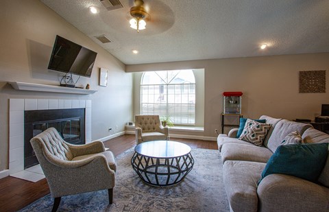 a living room with couches and chairs and a fireplace